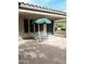 Inviting covered patio with a dining table, a shade umbrella, and an outdoor kitchen area at 12733 W Mine Trl, Peoria, AZ 85383