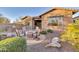 Charming backyard with a firepit and seating area, surrounded by desert landscaping and a built-in grill at 13719 W Creosote Dr, Peoria, AZ 85383