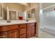 Bathroom with a double sink vanity, large mirror and a shower/tub combination at 13719 W Creosote Dr, Peoria, AZ 85383