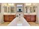 This bright, neutral bathroom features dual vanities flanking a picture window above the soaking tub at 13719 W Creosote Dr, Peoria, AZ 85383