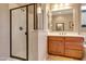 An elegant bathroom showcases a glass walk-in shower, vanity, and warm neutral paint at 13719 W Creosote Dr, Peoria, AZ 85383