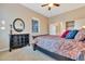 Cozy bedroom featuring a large bed and dresser with a decorative mirror above at 13719 W Creosote Dr, Peoria, AZ 85383