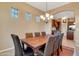 Elegant dining room featuring a chandelier, large window, and comfortable seating at 13719 W Creosote Dr, Peoria, AZ 85383