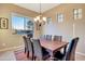 Inviting dining area with scenic views, wood table, and comfortable seating at 13719 W Creosote Dr, Peoria, AZ 85383