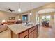 Open concept kitchen with large island, stainless steel sink, and modern finishes at 13719 W Creosote Dr, Peoria, AZ 85383