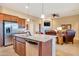 Modern kitchen with island, granite countertops, stainless appliances, and wood cabinetry at 13719 W Creosote Dr, Peoria, AZ 85383