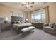 This expansive main bedroom features a decorative headboard, neutral tones, and bright natural lighting at 13719 W Creosote Dr, Peoria, AZ 85383