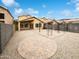 Expansive backyard featuring decorative gravel, brick accents, and a covered patio area at 1405 E Cathedral Rock Dr, Phoenix, AZ 85048