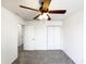 Bedroom with a ceiling fan, carpeted floors, and closet space at 1405 E Cathedral Rock Dr, Phoenix, AZ 85048