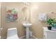 Bathroom featuring pedestal sink, oval mirror and neutral walls at 1458 N 80Th Ln, Phoenix, AZ 85043