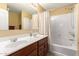 Bathroom showcasing a double sink vanity and a shower/tub combo at 1458 N 80Th Ln, Phoenix, AZ 85043