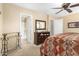 Bedroom with a ceiling fan and doorway leading to a full bathroom at 1458 N 80Th Ln, Phoenix, AZ 85043