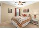 Bedroom with a comfortable bed, ceiling fan, and decorative artwork on the walls at 1458 N 80Th Ln, Phoenix, AZ 85043