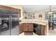 Well-equipped kitchen with granite countertops and stainless steel refrigerator at 1458 N 80Th Ln, Phoenix, AZ 85043