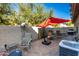 Secluded patio featuring a large red umbrella and outdoor seating at 1458 N 80Th Ln, Phoenix, AZ 85043