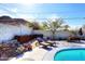 Inviting backyard featuring a hot tub, stone accents, lounge chairs, and sparkling pool at 1515 E Sunnyslope Ln, Phoenix, AZ 85020