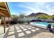 Spacious backyard with a pristine pool, patio area, and lush greenery with mountain views at 1515 E Sunnyslope Ln, Phoenix, AZ 85020