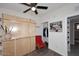 Cozy bedroom featuring a closet, ceiling fan, and a wooden wall-mounted shelving unit at 1515 E Sunnyslope Ln, Phoenix, AZ 85020