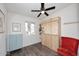 Bright bedroom with a ceiling fan, hardwood floors, and a wall-mounted desk unit at 1515 E Sunnyslope Ln, Phoenix, AZ 85020