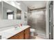 Bright bathroom featuring a single sink vanity, large mirror, and a glass-enclosed shower with neutral tones at 16036 N 11Th Ave # 1126, Phoenix, AZ 85023