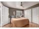 Comfortable bedroom featuring warm tones, ample closet space, and a ceiling fan at 16036 N 11Th Ave # 1126, Phoenix, AZ 85023