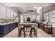 Stylish kitchen featuring white and blue cabinetry, tile backsplash, and stainless steel appliances at 16036 N 11Th Ave # 1126, Phoenix, AZ 85023