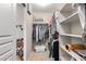 Spacious walk-in closet featuring built-in shelving, hanging rods, and ample storage space for clothes and accessories at 16036 N 11Th Ave # 1126, Phoenix, AZ 85023