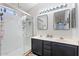 Bathroom featuring double sinks, mirrors, and a shower stall with a glass door at 16618 S 28Th Pl, Phoenix, AZ 85048