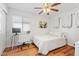 Cozy bedroom with a comfortable bed, white desk, and a large window allowing natural light at 16618 S 28Th Pl, Phoenix, AZ 85048