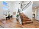 Spacious living room with hardwood floors, a large window, and a staircase leading to the second floor at 16618 S 28Th Pl, Phoenix, AZ 85048