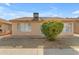 View of the rear exterior highlighting a well-kept yard and mature bushes at 1706 E Lindrick Dr, Chandler, AZ 85249