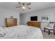 Cozy bedroom with ceiling fan, wooden dresser, and chair at 1706 E Lindrick Dr, Chandler, AZ 85249