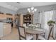 Bright dining area with chandelier lighting situated off the kitchen for easy access at 1706 E Lindrick Dr, Chandler, AZ 85249