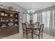 Charming dining room boasts elegant chandelier, bright windows, and built-in display cabinet at 1706 E Lindrick Dr, Chandler, AZ 85249