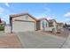 Well-maintained home exterior showcasing a two-car garage and desert landscaping at 1706 E Lindrick Dr, Chandler, AZ 85249