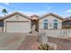 Home's inviting front yard with desert landscape and two-car garage at 1706 E Lindrick Dr, Chandler, AZ 85249