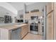 Well-lit kitchen featuring stainless steel appliances, ample counter space, and open layout at 1706 E Lindrick Dr, Chandler, AZ 85249