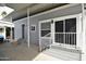 Exterior view of the house with covered entrance, steps with white railings, and a welcoming doormat at 17200 W Bell Rd # 958, Surprise, AZ 85374