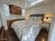 Comfortable main bedroom with wood-like floors, lamps, and a queen-size bed at 17200 W Bell Rd # 958, Surprise, AZ 85374