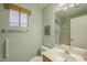 Well-lit bathroom featuring a vanity with sink, toilet, and walk-in shower at 1793 E Desert Inn Dr, Chandler, AZ 85249