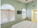 Bright bedroom showcasing arch windows, tv, and ceiling fan at 1793 E Desert Inn Dr, Chandler, AZ 85249