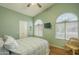 Bedroom with high ceiling, fan, wood floors, and arch windows at 1793 E Desert Inn Dr, Chandler, AZ 85249