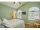 Bedroom with high ceiling, fan, walk in closet, wood floors, and arch windows at 1793 E Desert Inn Dr, Chandler, AZ 85249