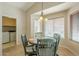 Bright dining area with wood table, chandelier, and a view of the laundry room at 1793 E Desert Inn Dr, Chandler, AZ 85249