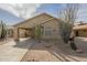 Tan home featuring drought-resistant desert landscaping including cacti and stone ground cover at 1793 E Desert Inn Dr, Chandler, AZ 85249