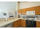 Kitchen showcasing stainless steel dishwasher, tiled countertops, and wood cabinets at 1793 E Desert Inn Dr, Chandler, AZ 85249