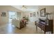 Cozy living room with tile flooring, vaulted ceiling, and sliding glass doors to the backyard at 1793 E Desert Inn Dr, Chandler, AZ 85249