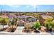 Aerial view of a residential neighborhood featuring two-story homes with solar panels and desert landscaping at 18225 W Mackenzie Dr, Goodyear, AZ 85395