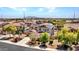 Aerial view of a residential neighborhood featuring two-story homes, solar panels, and desert landscaping at 18225 W Mackenzie Dr, Goodyear, AZ 85395