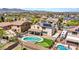 Aerial view showcasing a backyard oasis with a pool, putting green, and RV parking at 18225 W Mackenzie Dr, Goodyear, AZ 85395